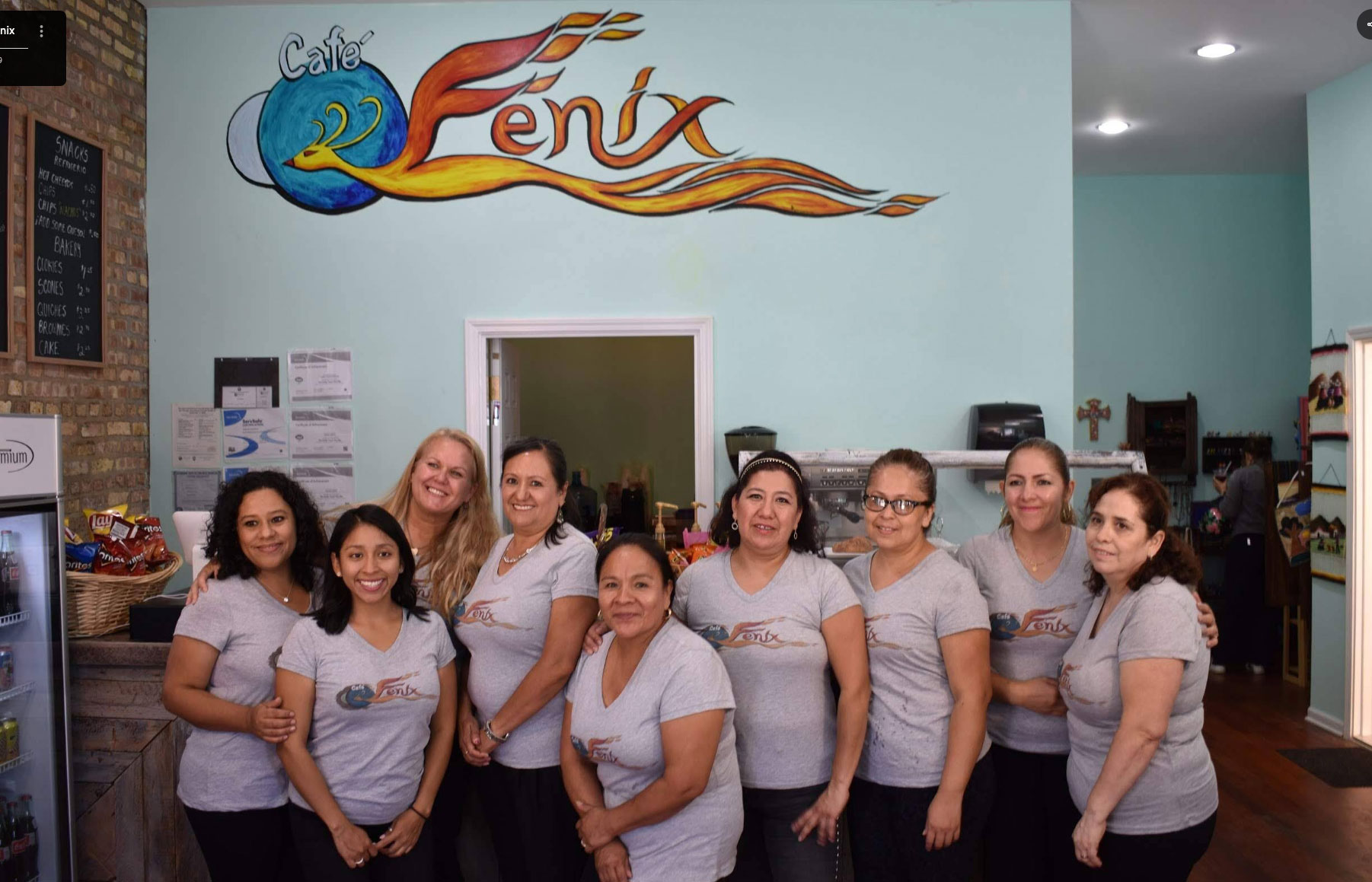The Café Fénix team behind the counter, in front of the phoenix mural